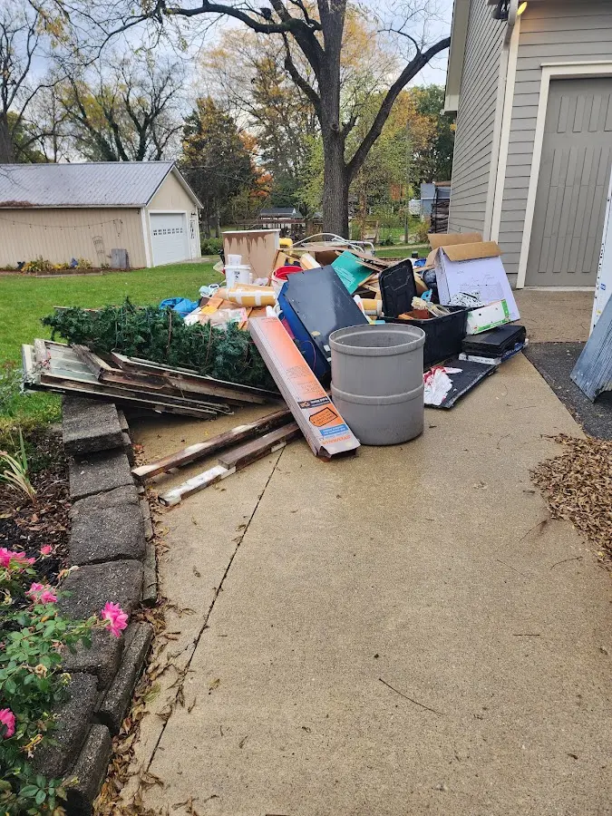 Dumpster being loaded with debris for Estate Cleanout Dumpster Rental in Lake City